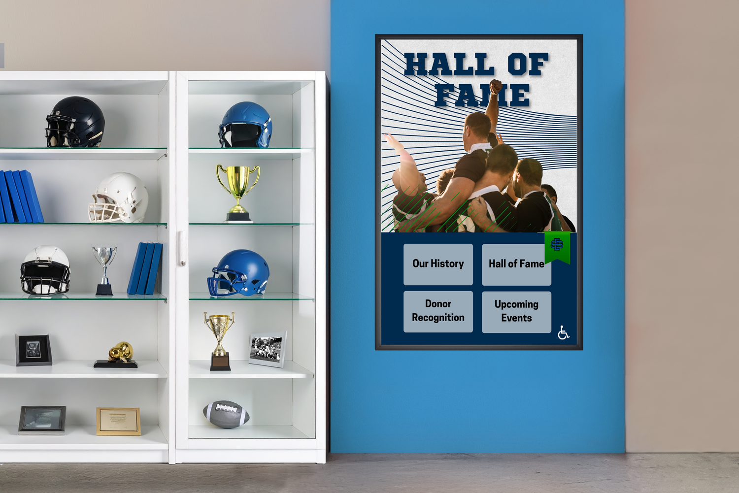 Hall of Fame poster on a blue wall with sports memorabilia in a cabinet.