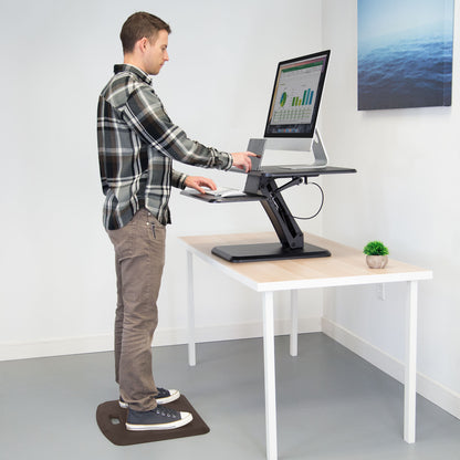 standing man working on computer