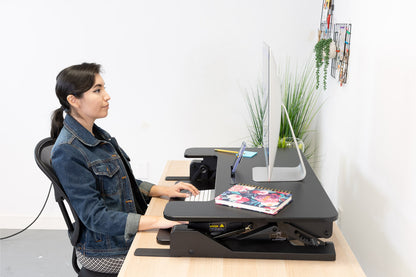 sitting woman on computer